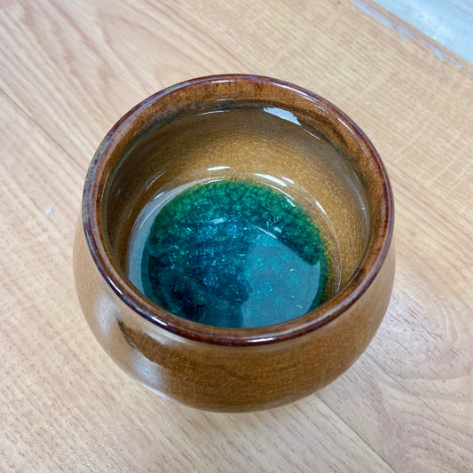 Saturn brown teacup with green crystal inside